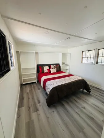 a bedroom with a bed a dresser and a window