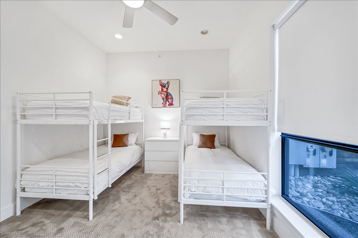 1101 Ivean Pearson Road, Unit A102 Lago Vista, TX 78645 - Photo 14 of 31 Carpeted bedroom with ceiling fan and recessed lighting
