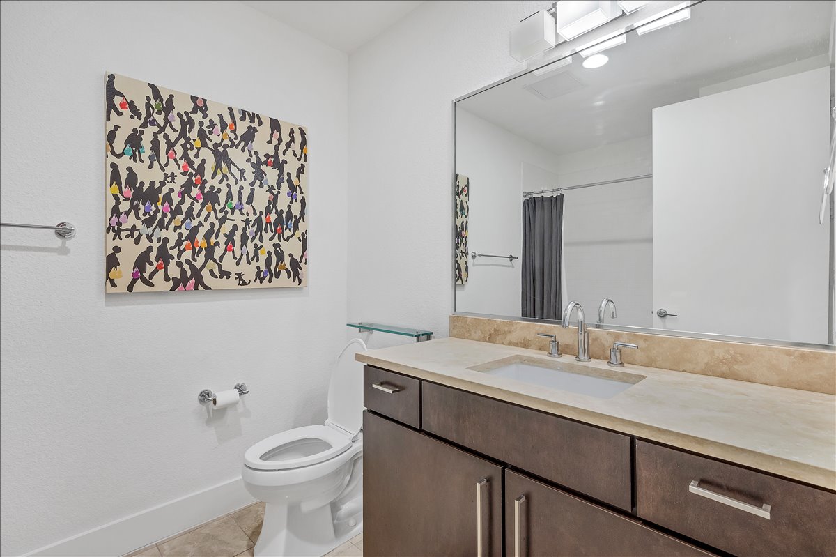 1101 Ivean Pearson Road, Unit A102 Lago Vista, TX 78645 - Photo 15 of 31 Bathroom with vanity, light tile patterned floors, and curtained shower