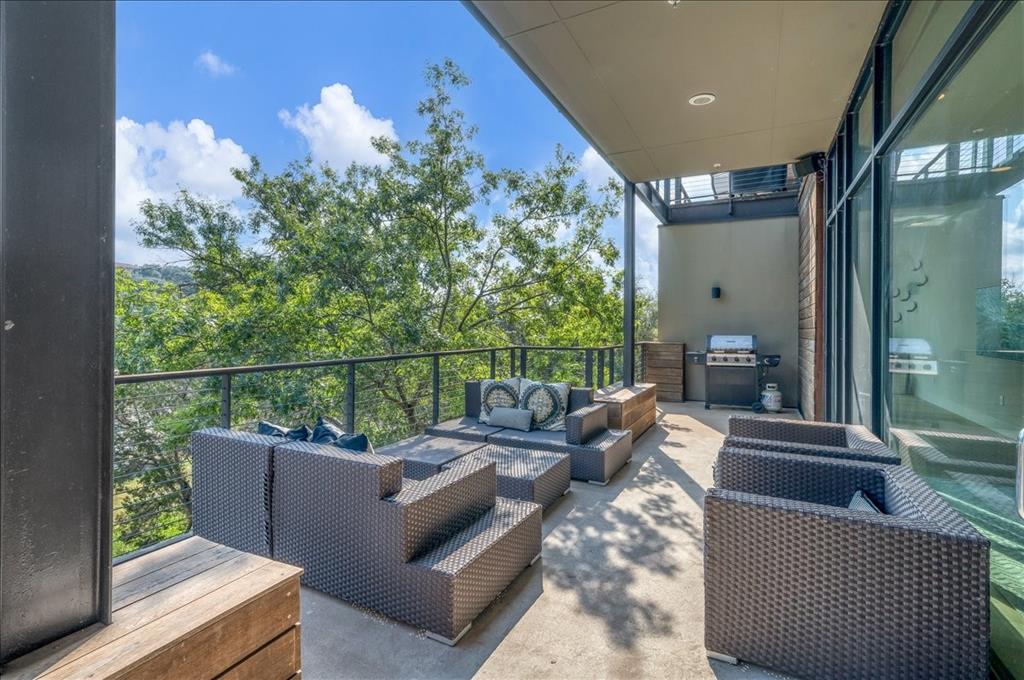 1101 Ivean Pearson Road, Unit A102 Lago Vista, TX 78645 - Photo 21 of 31 Balcony with an outdoor living space, a sunroom, and grilling area