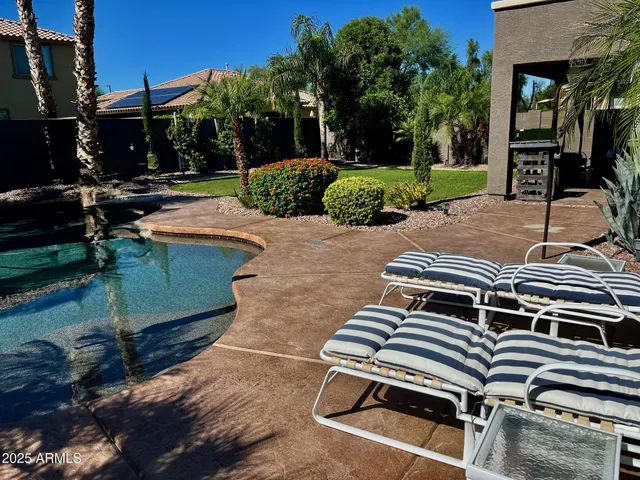 a view of a patio with table and chairs with wooden floor and fence