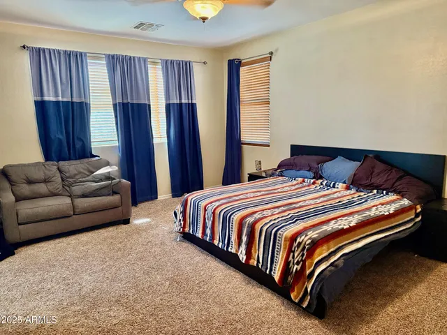 a bedroom with bed and wooden floor