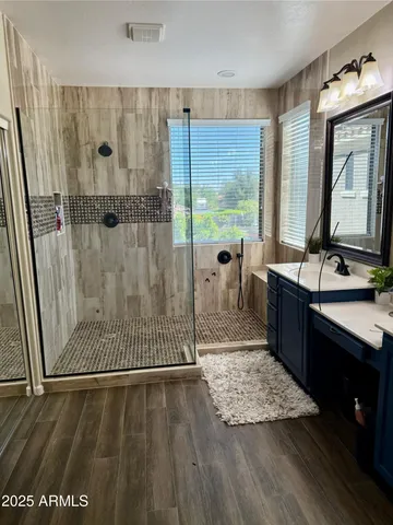 a view of a bathroom with wooden floor and a sink