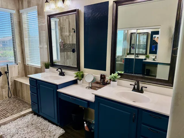 a bathroom with a double vanity sink and a mirror