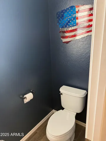 a white toilet sitting next to a shower