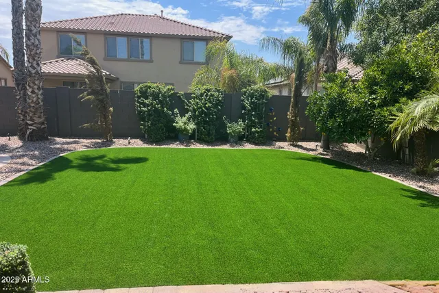 a view of a house with a yard and sitting area