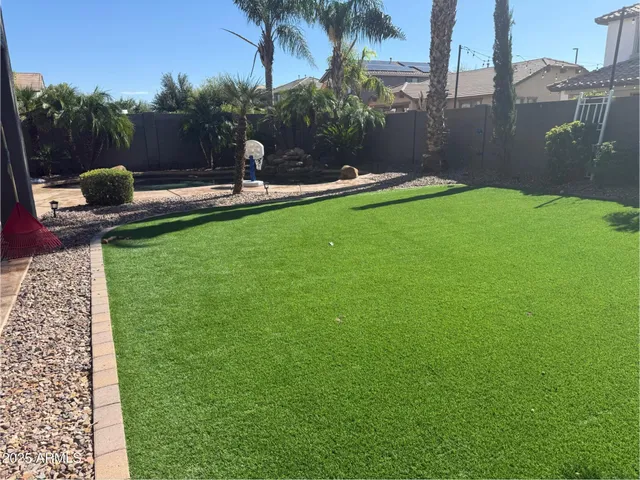a backyard of a house with table and chairs