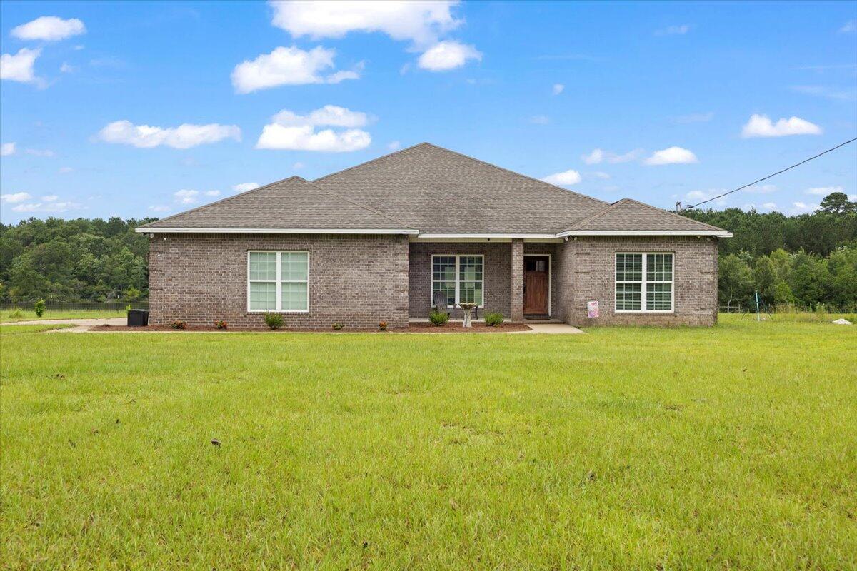 7938 Steel Mill Creek Road Laurel Hill, FL 32567 - Photo 1 of 33 a front view of house with yard and green space