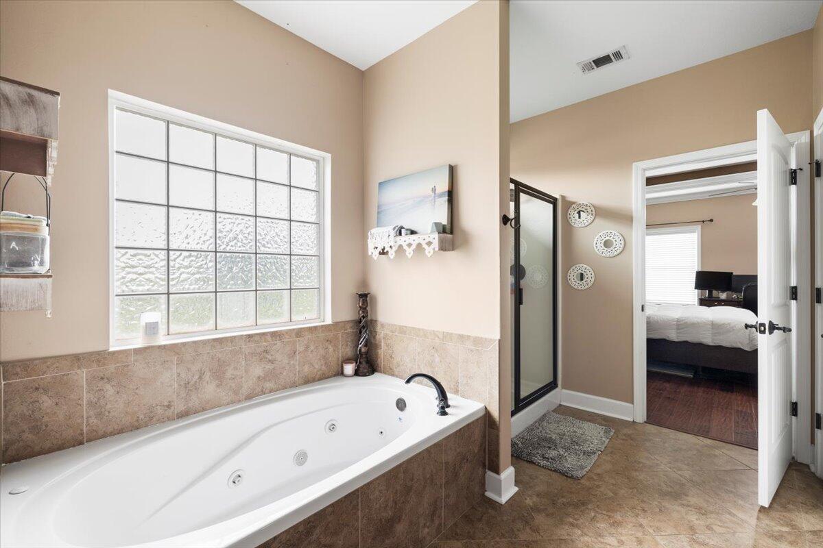 7938 Steel Mill Creek Road Laurel Hill, FL 32567 - Photo 16 of 33 a bathroom with a bathtub and a sink