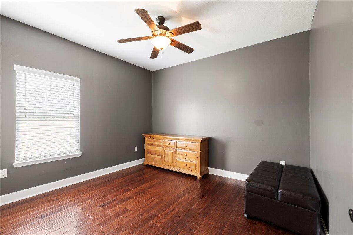 7938 Steel Mill Creek Road Laurel Hill, FL 32567 - Photo 20 of 33 a room with bed and wooden floor
