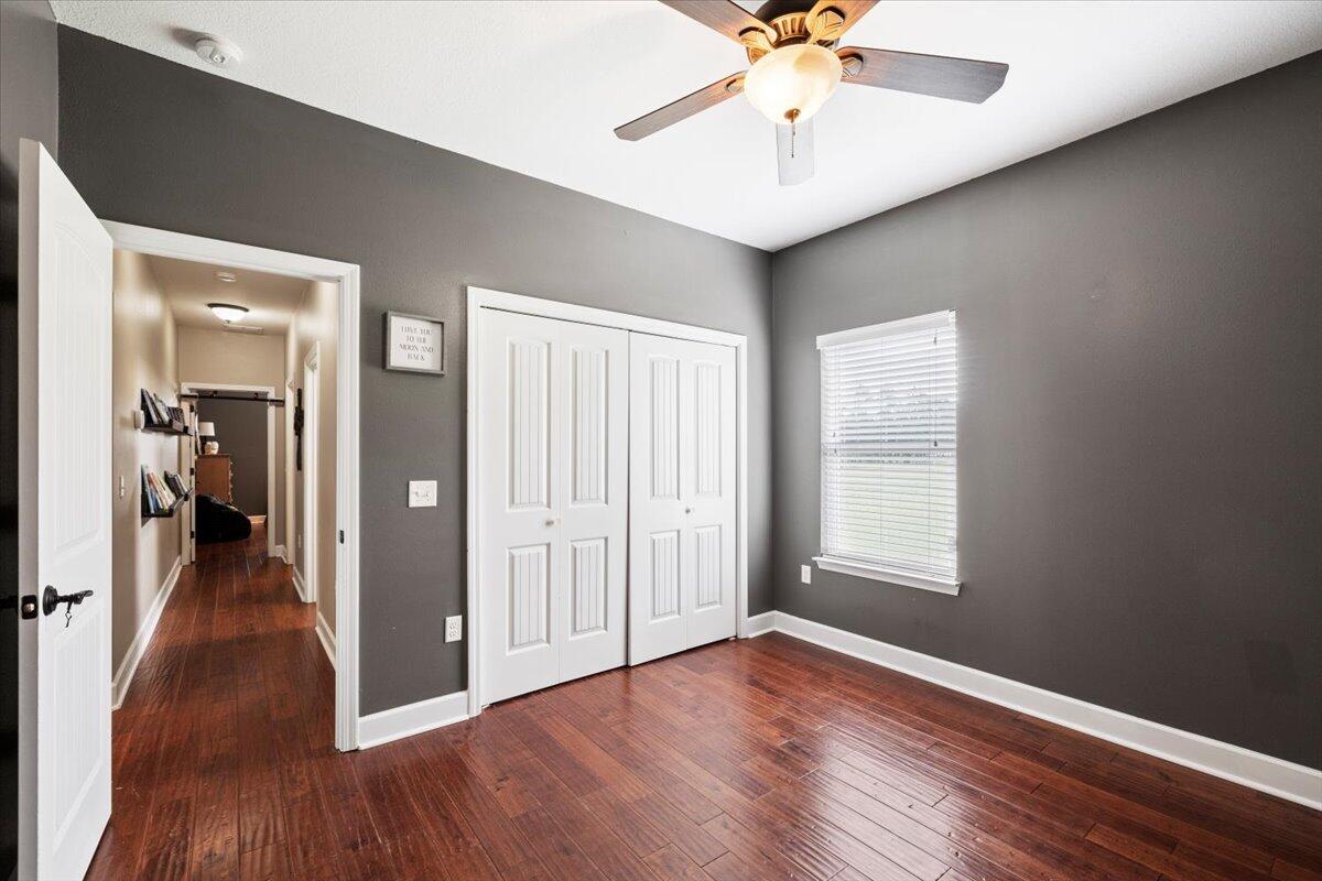 7938 Steel Mill Creek Road Laurel Hill, FL 32567 - Photo 21 of 33 wooden floor in an empty room with a window
