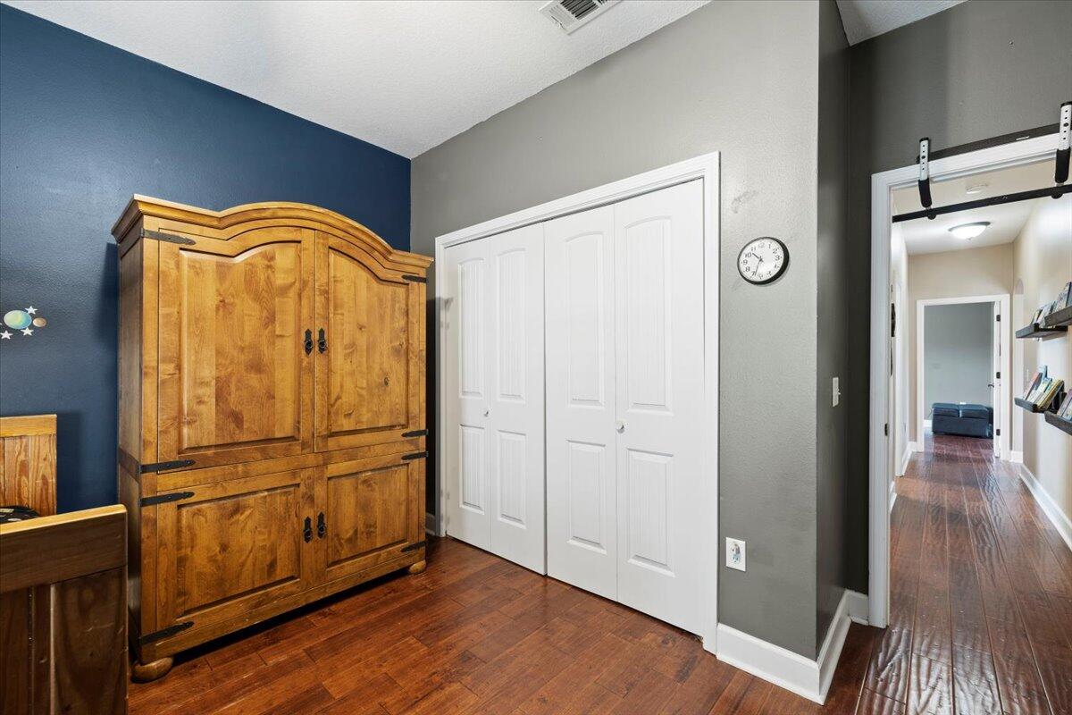 7938 Steel Mill Creek Road Laurel Hill, FL 32567 - Photo 22 of 33 a view of empty room with wooden floor