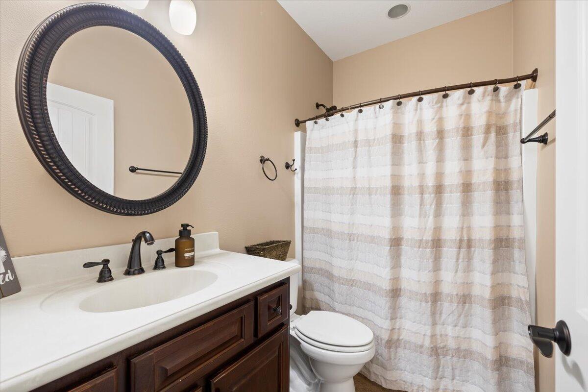 7938 Steel Mill Creek Road Laurel Hill, FL 32567 - Photo 25 of 33 a bathroom with a sink and a mirror