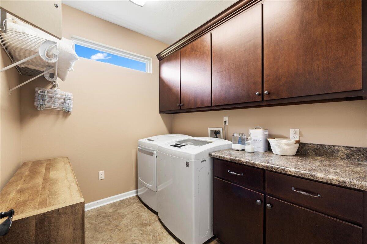 7938 Steel Mill Creek Road Laurel Hill, FL 32567 - Photo 26 of 33 a utility room with granite countertop cabinets and washer