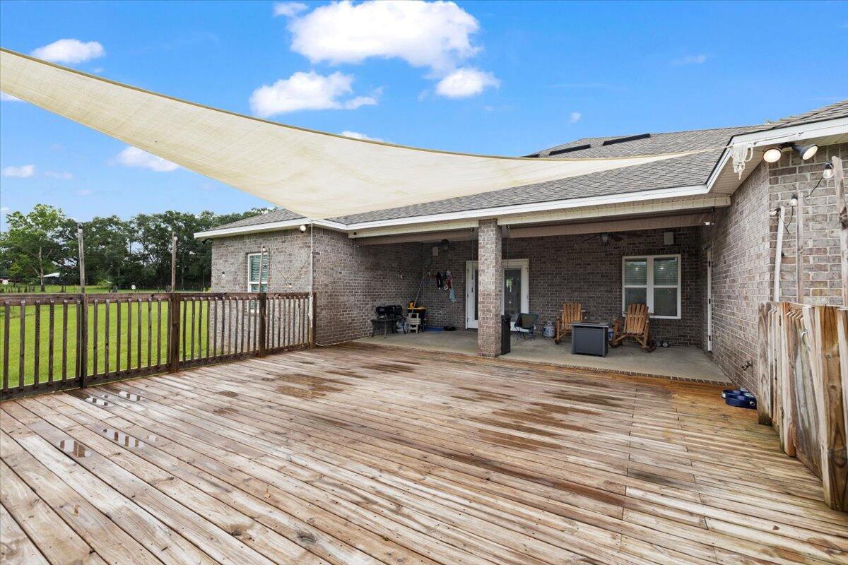 7938 Steel Mill Creek Road Laurel Hill, FL 32567 - Photo 27 of 33 a view of backyard with deck and outdoor seating
