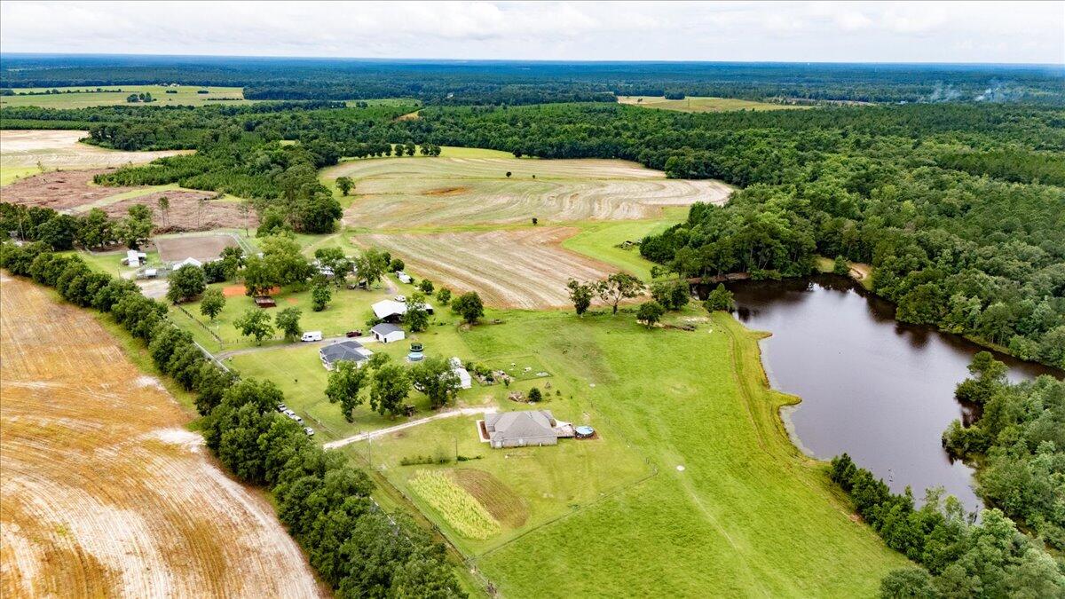 7938 Steel Mill Creek Road Laurel Hill, FL 32567 - Photo 29 of 33 a view of a lake with a yard