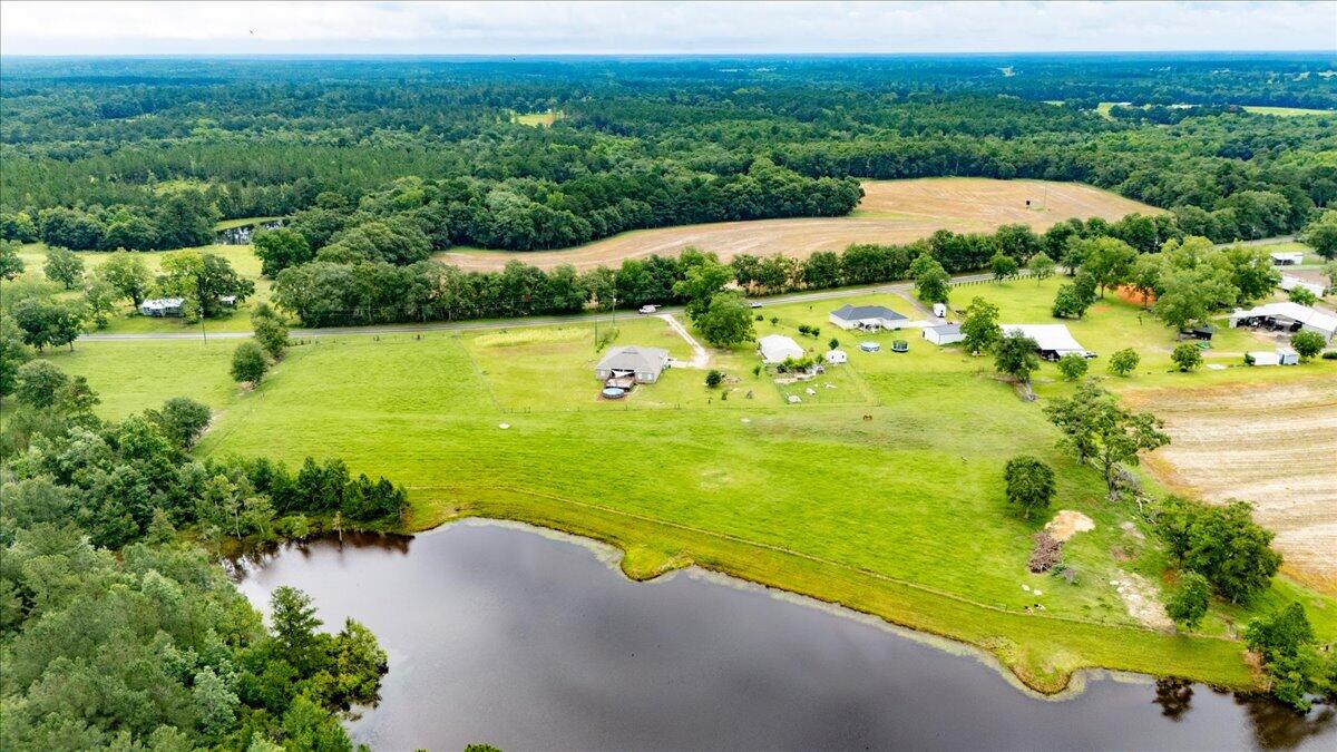 7938 Steel Mill Creek Road Laurel Hill, FL 32567 - Photo 3 of 33 a view of a lake with a yard