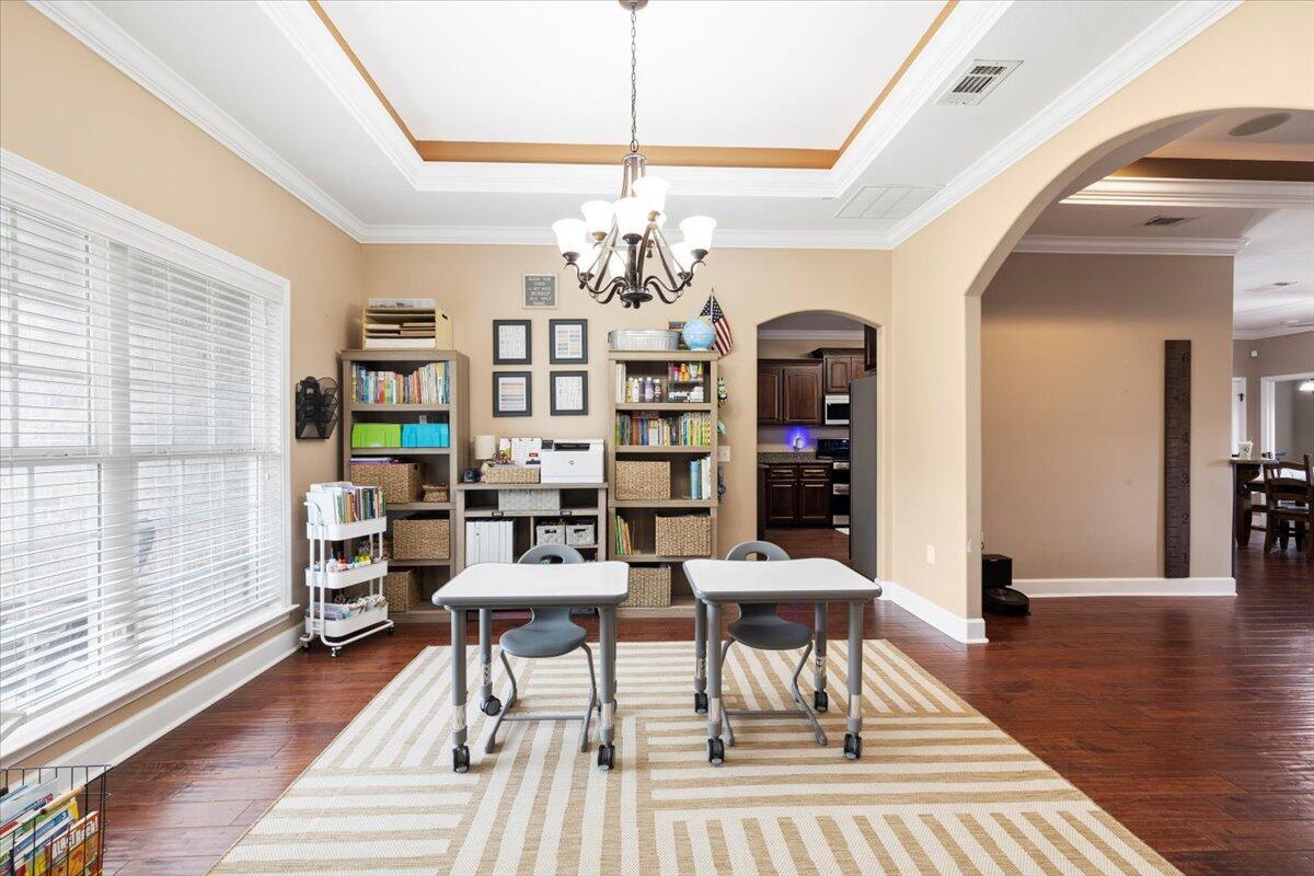 7938 Steel Mill Creek Road Laurel Hill, FL 32567 - Photo 8 of 33 a view of a livingroom with furniture wooden floor and chandelier