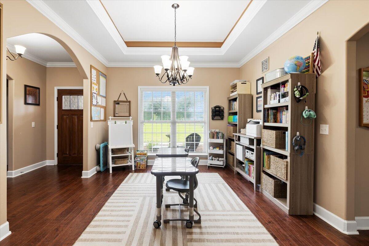 7938 Steel Mill Creek Road Laurel Hill, FL 32567 - Photo 9 of 33 a very nice looking room with a large window and wooden floor