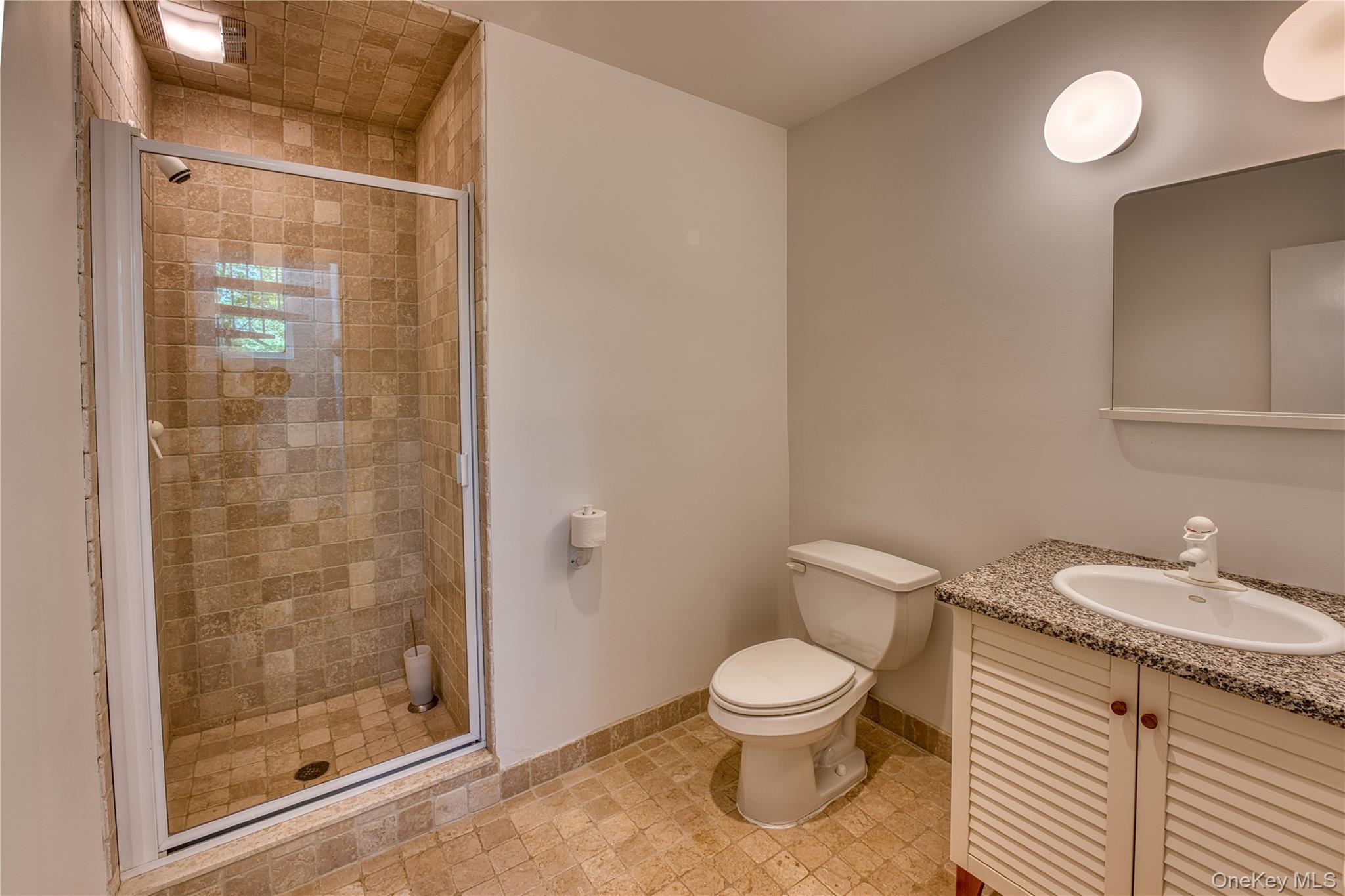 61 Indian Brook Road Garrison, NY 10524 - Photo 17 of 23 a white toilet sitting next to a bathroom sink
