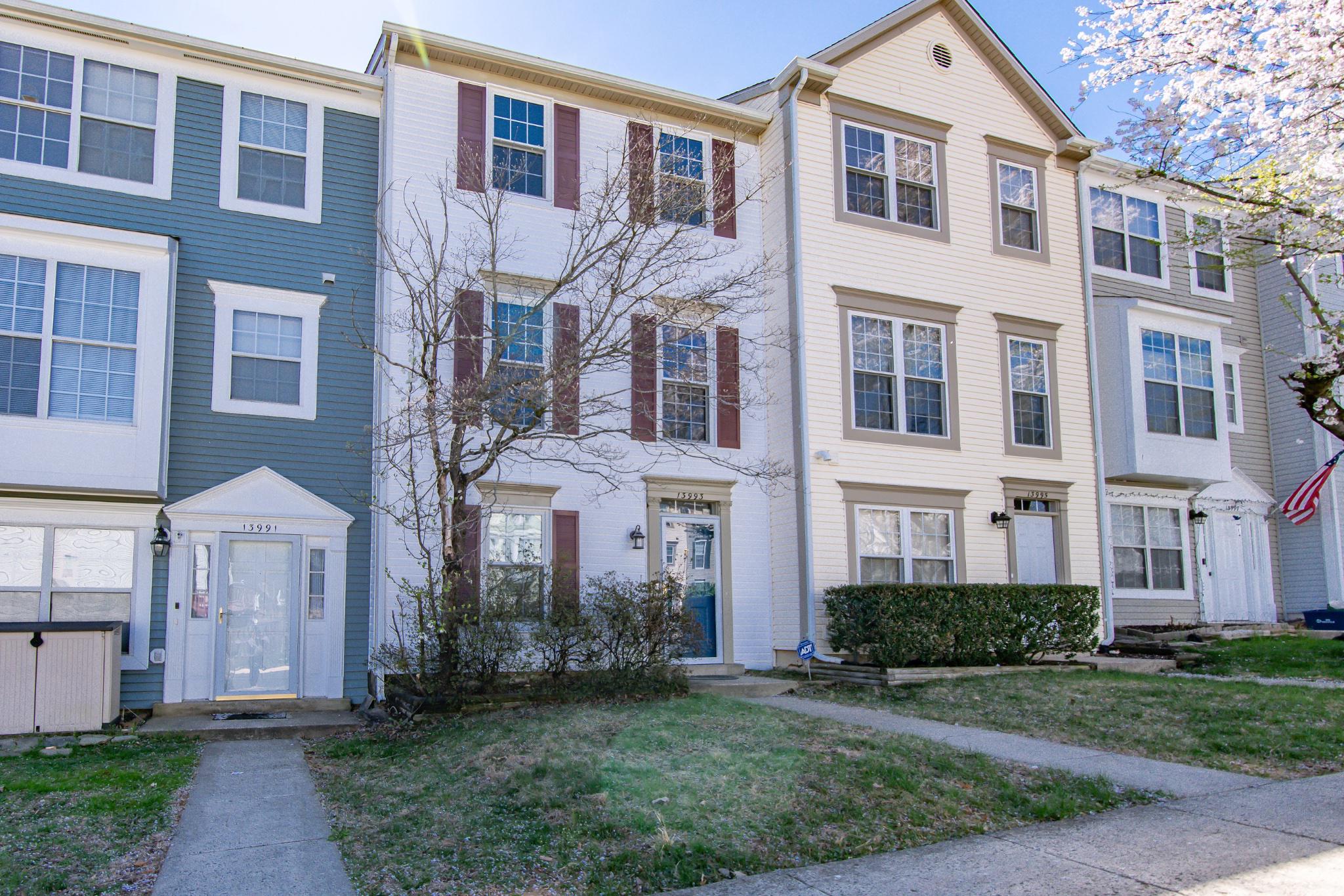 13993 Gunners Place Centreville, VA 20121 - Photo 1 of 43 a front view of a residential apartment building with a yard