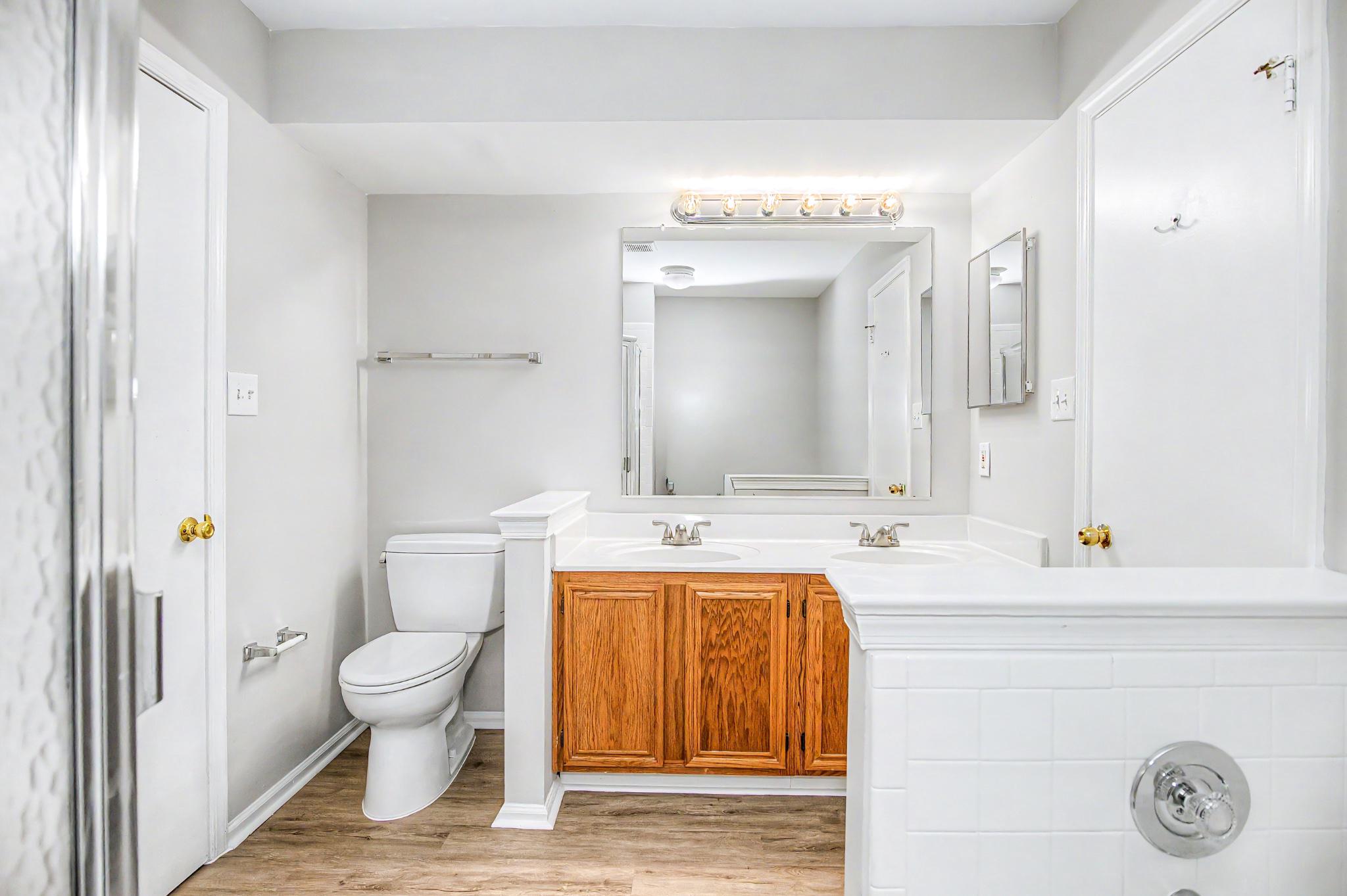 13993 Gunners Place Centreville, VA 20121 - Photo 28 of 43 a bathroom with a granite countertop sink a toilet and a mirror