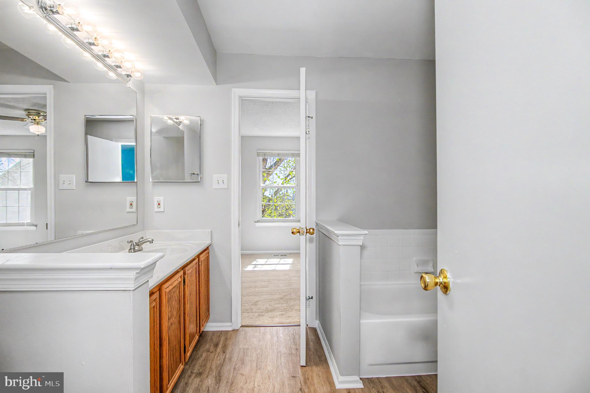 13993 Gunners Place Centreville, VA 20121 - Photo 32 of 43 a bathroom with a sink a toilet and a mirror