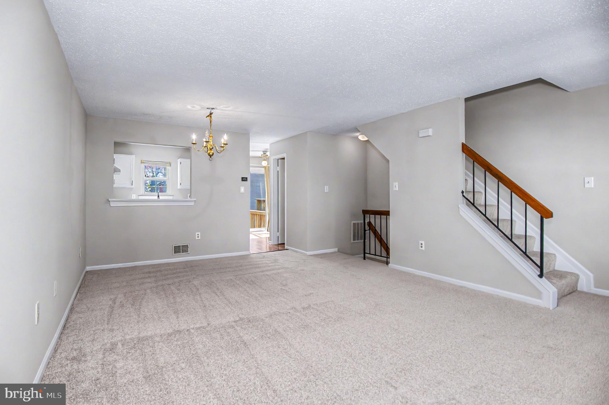 13993 Gunners Place Centreville, VA 20121 - Photo 4 of 43 a view of an empty room with stairs and a window