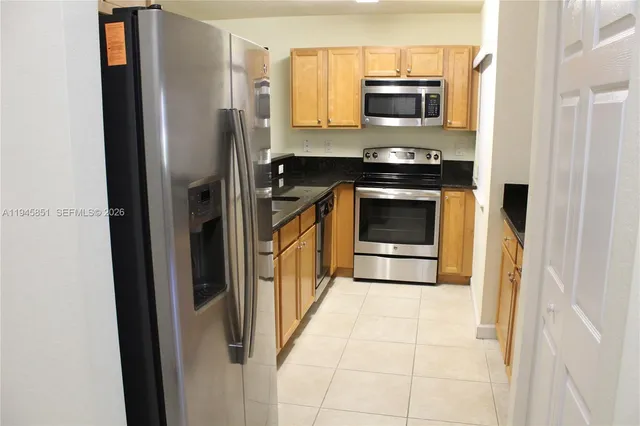 a kitchen with a stove and a refrigerator