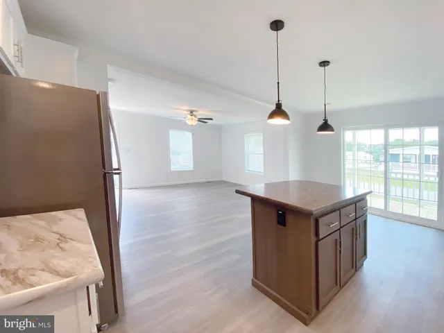a kitchen with counter top space and wooden floor