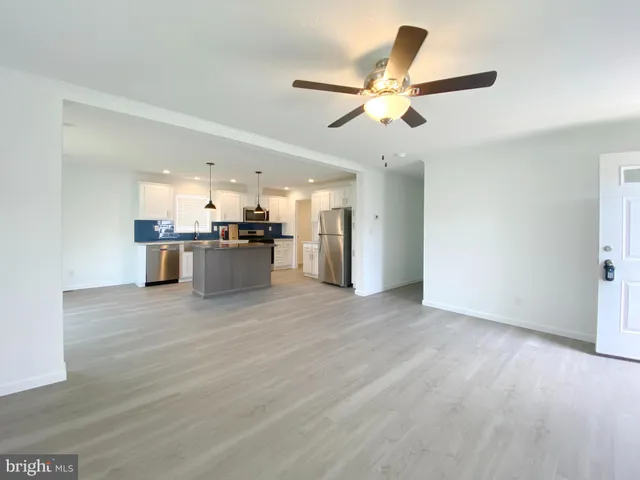 a view of a kitchen with a sink and a refrigerator