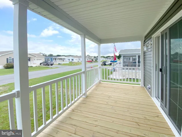 a view of a porch with wooden floor and outdoor space