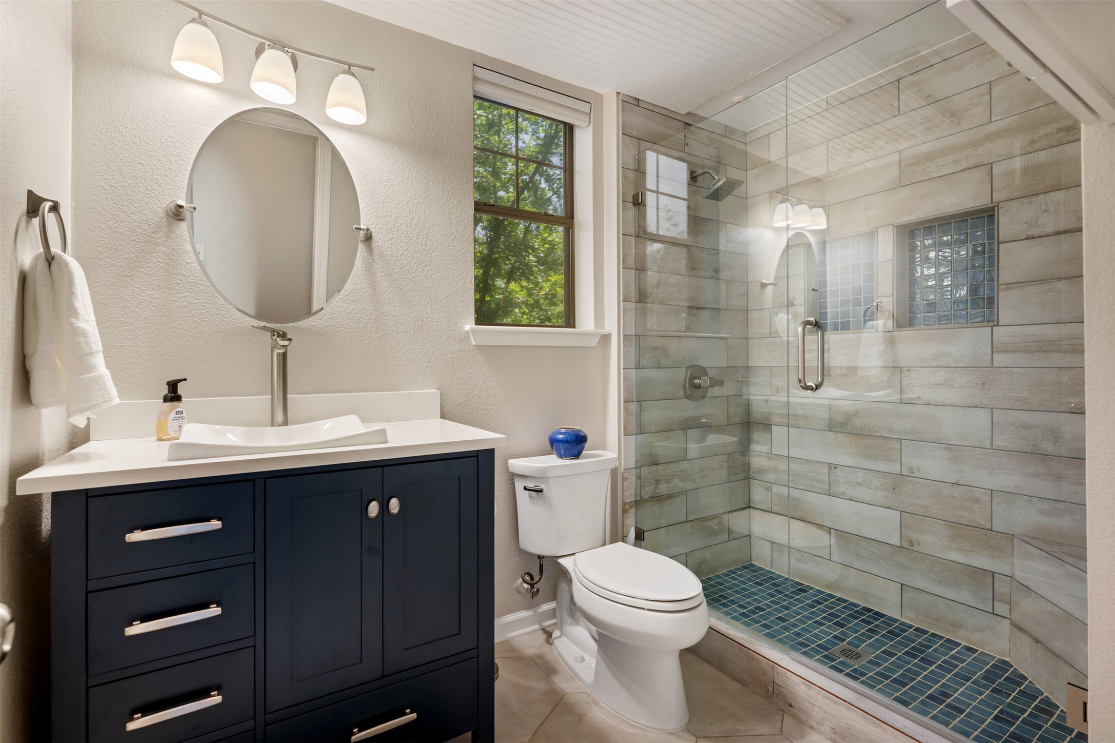 11203 Ranch Road 2222, Unit 1407 Austin, TX 78732 - Photo 33 of 40 The full guest bathroom on the main floor is also tastefully updated with desirable modern finishes including a spa-inspired frameless glass walk-in shower.