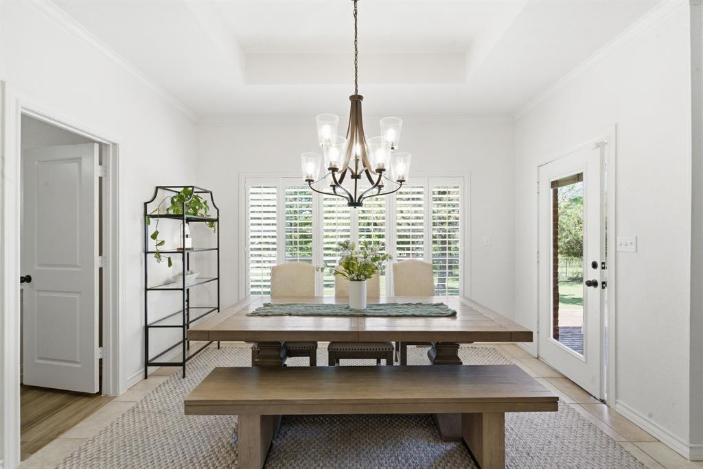 405 Zion Hill Road Weatherford, TX 76088 - Photo 12 of 38 Dining room with suspended lighting, plenty of natural light, and ornamental molding