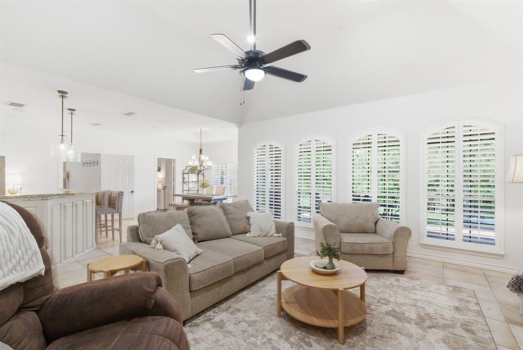 405 Zion Hill Road Weatherford, TX 76088 - Photo 15 of 38 Living area featuring ceiling fan, hanging lights, light tile patterned floors, and vaulted ceiling