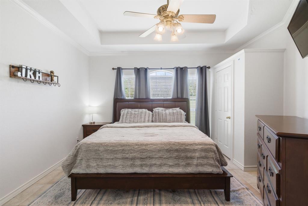 405 Zion Hill Road Weatherford, TX 76088 - Photo 16 of 38 Bedroom featuring crown molding, a ceiling fan, and a tray ceiling