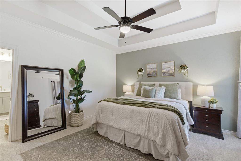 405 Zion Hill Road Weatherford, TX 76088 - Photo 20 of 38 Bedroom with light carpet, a raised ceiling, crown molding, a ceiling fan, and connected bathroom