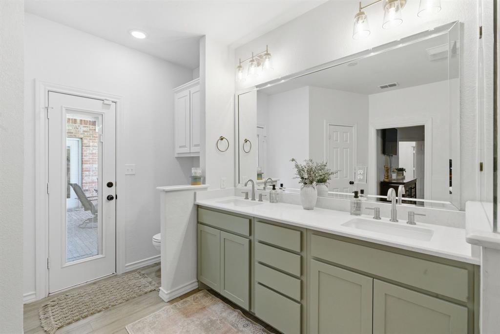 405 Zion Hill Road Weatherford, TX 76088 - Photo 23 of 38 Bathroom featuring double vanity and light wood finished floors