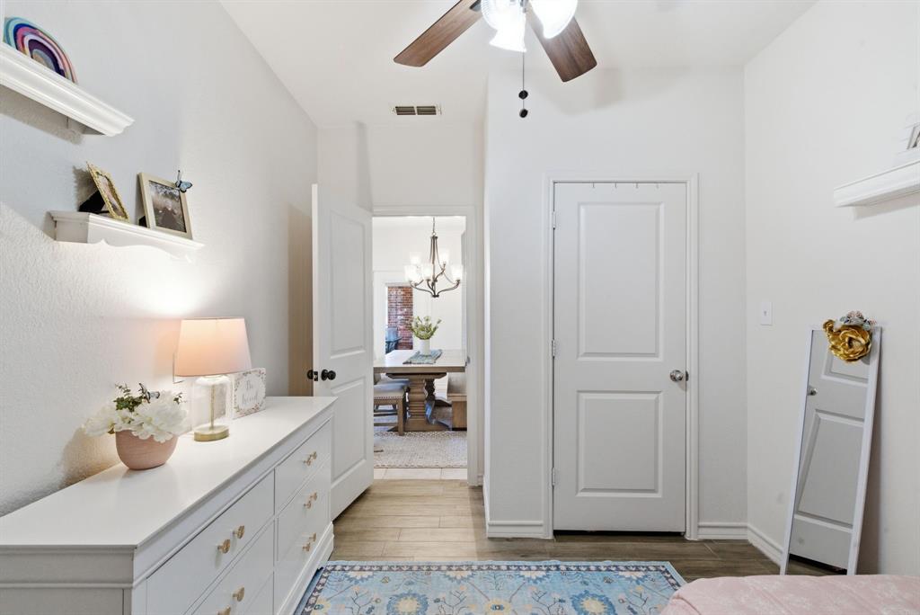 405 Zion Hill Road Weatherford, TX 76088 - Photo 28 of 38 Bedroom featuring suspended lighting, light wood finished floors, and a ceiling fan