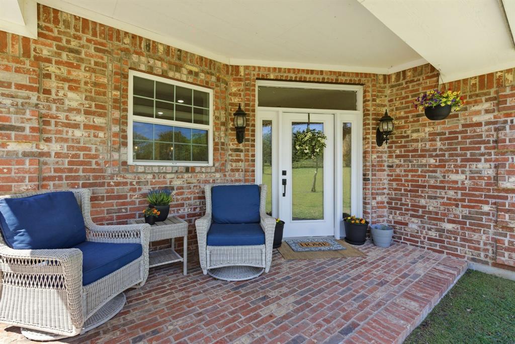 405 Zion Hill Road Weatherford, TX 76088 - Photo 30 of 38 View of exterior entry with brick siding and a patio area