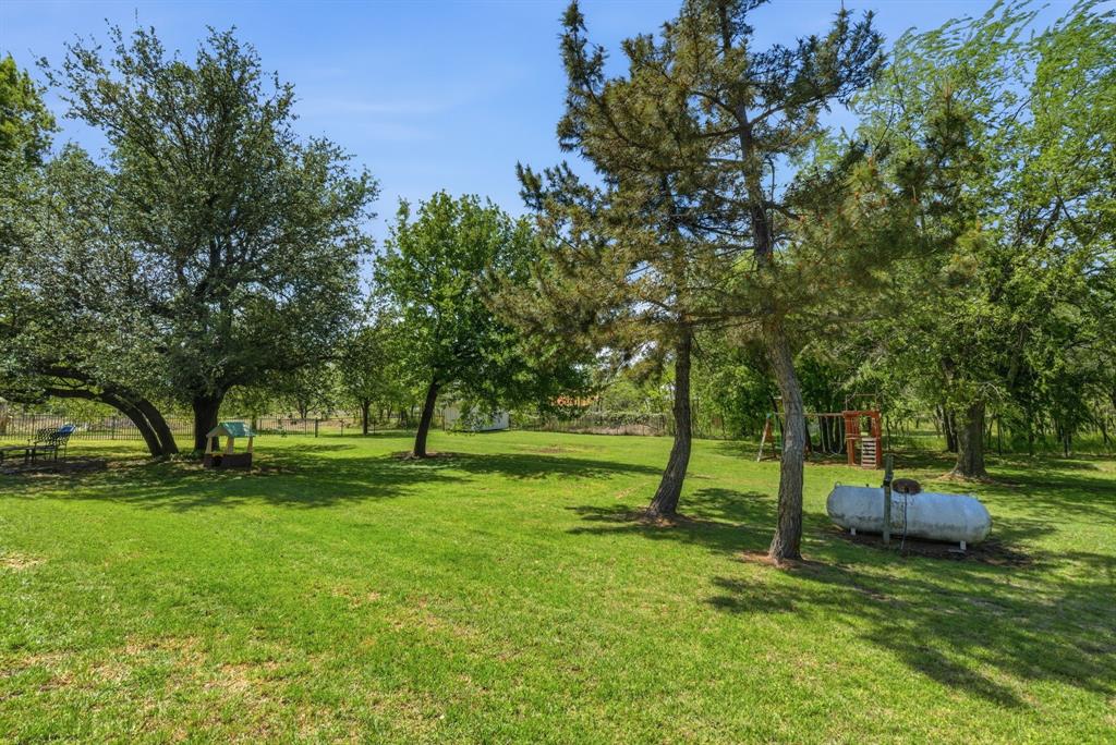 405 Zion Hill Road Weatherford, TX 76088 - Photo 38 of 38 View of grassy yard with view of wooded area