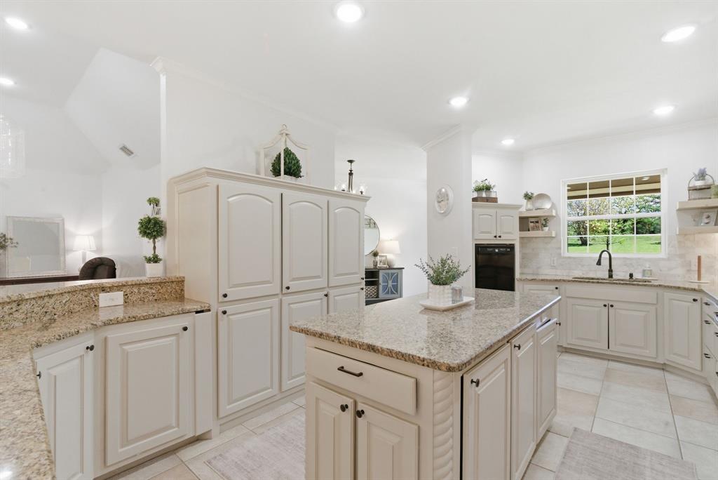 405 Zion Hill Road Weatherford, TX 76088 - Photo 7 of 38 Kitchen featuring a kitchen island, light stone counters, open shelves, crown molding, and recessed lighting