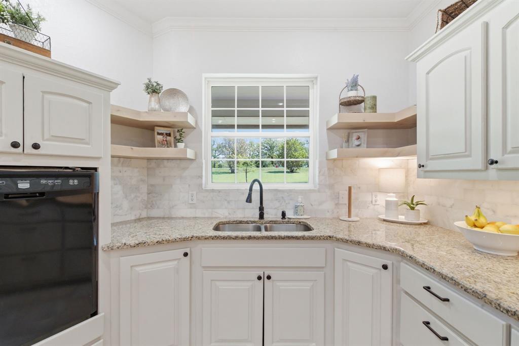 405 Zion Hill Road Weatherford, TX 76088 - Photo 8 of 38 Kitchen with oven, light stone counters, white cabinetry, open shelves, and crown molding