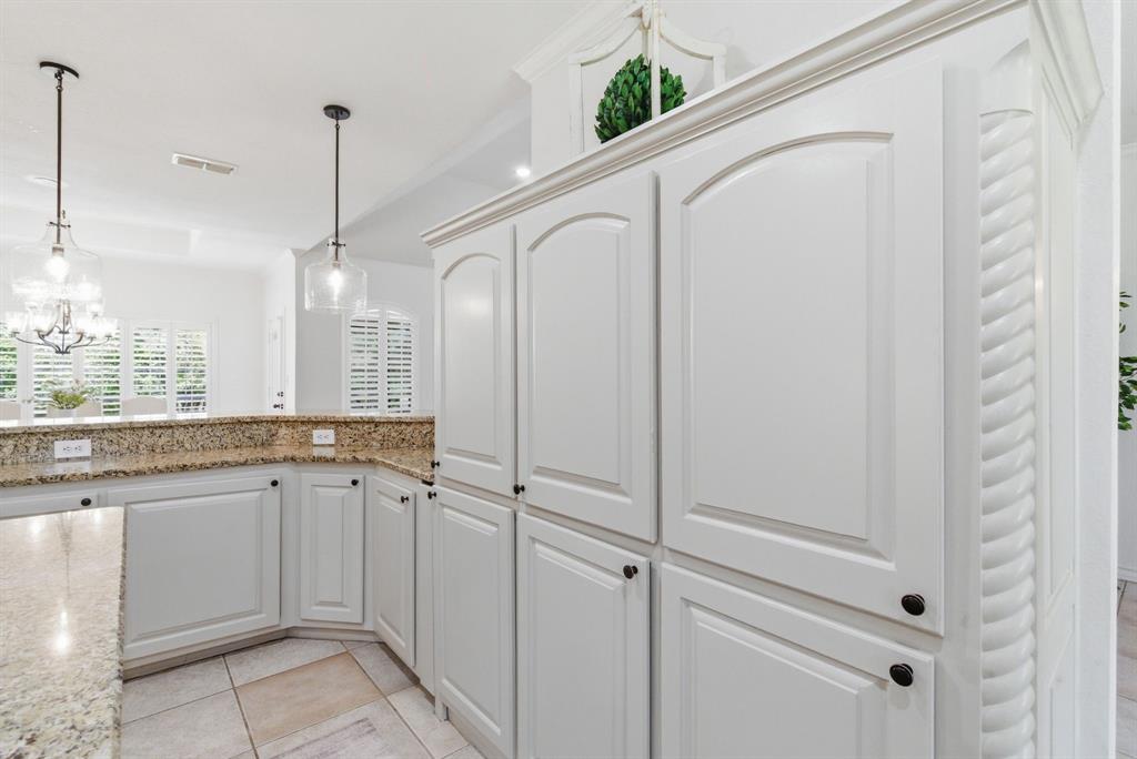 405 Zion Hill Road Weatherford, TX 76088 - Photo 10 of 38 Kitchen with light stone counters, white cabinets, light tile patterned floors, and a chandelier