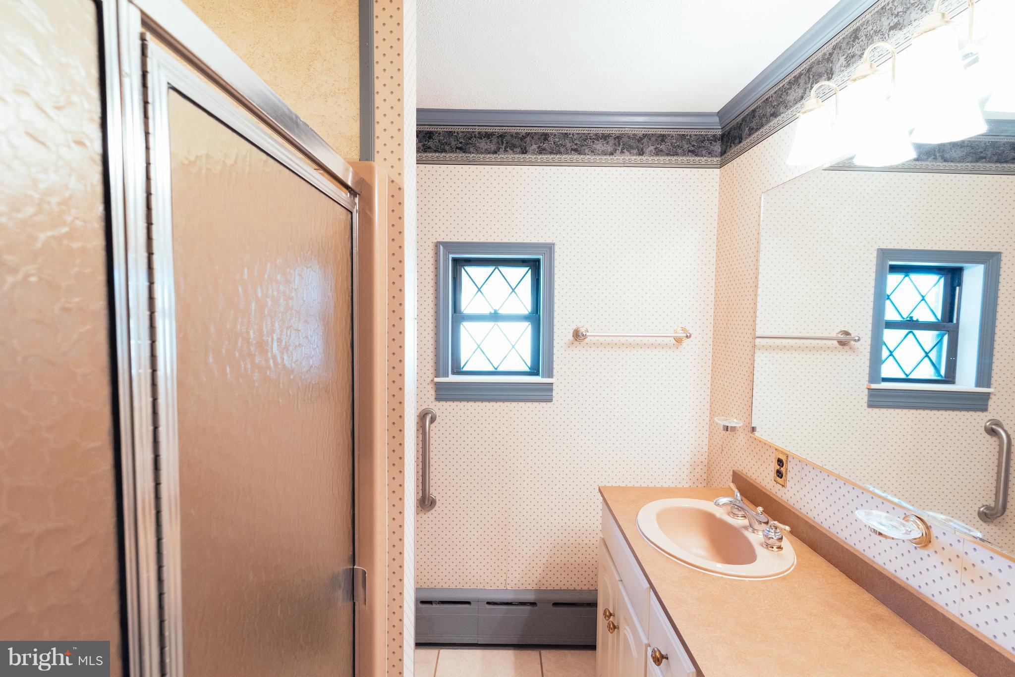 16600 York Road Monkton, MD 21111 - Photo 12 of 30 a bathroom with a granite countertop sink a mirror and a shower
