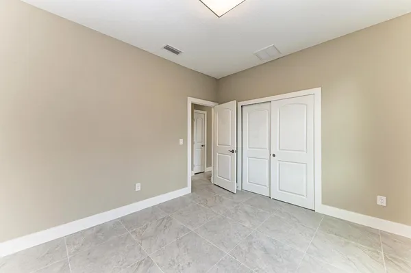 a view of an empty room and closet area