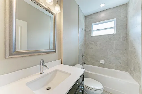 a bathroom with a sink toilet and bathtub