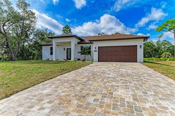 a view of a house with a yard and garage