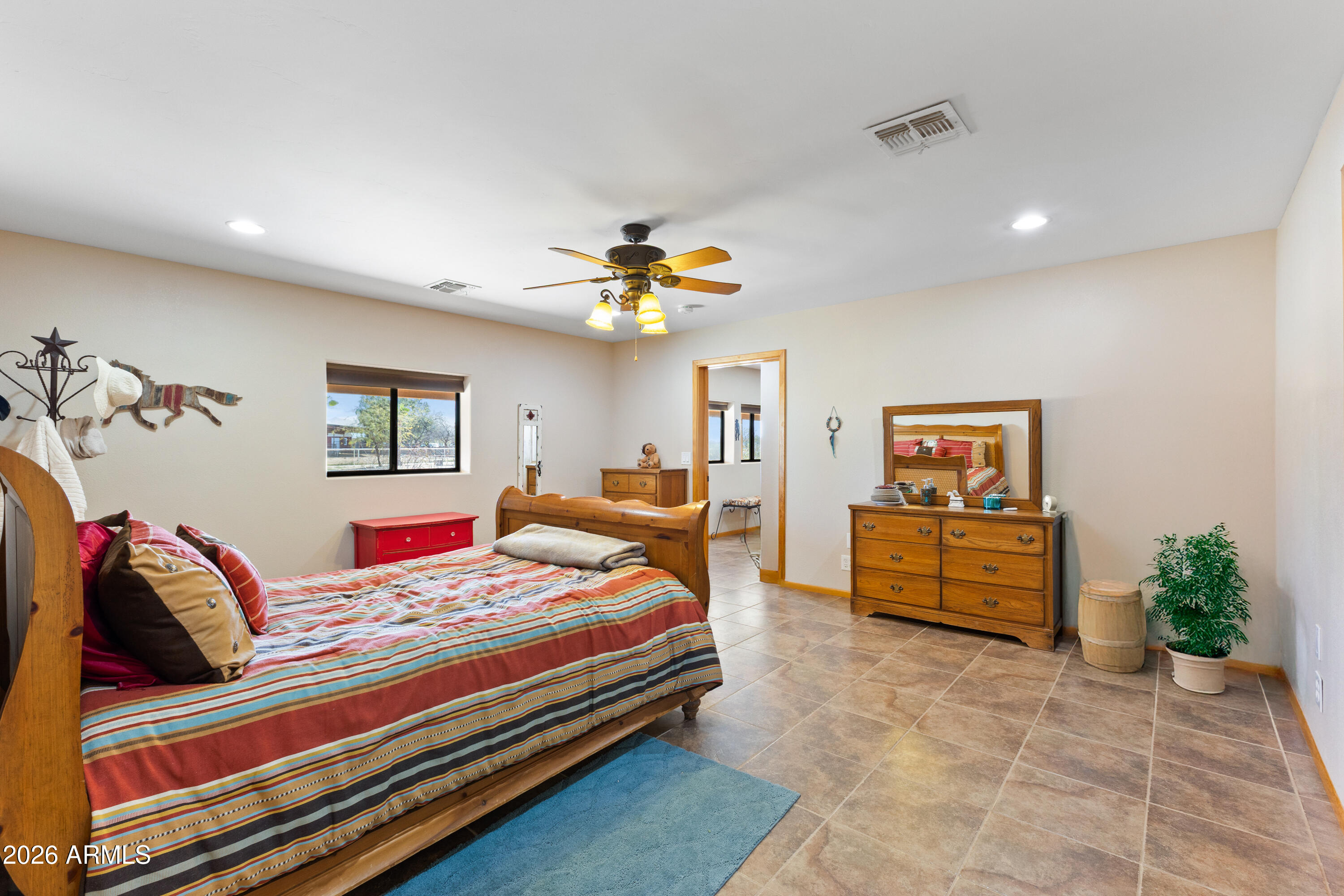 20526 West Carver Road Buckeye, AZ 85326 - Photo 22 of 43 a bedroom with a bed and wooden floor