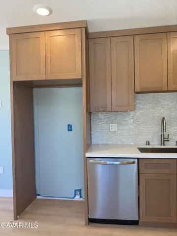 a close view of sink and cabinets